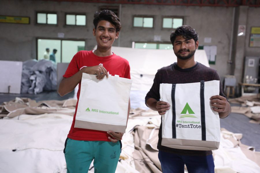 boys standing with Tenttotes a bag of full hope Tenttotes CSR upcycling project